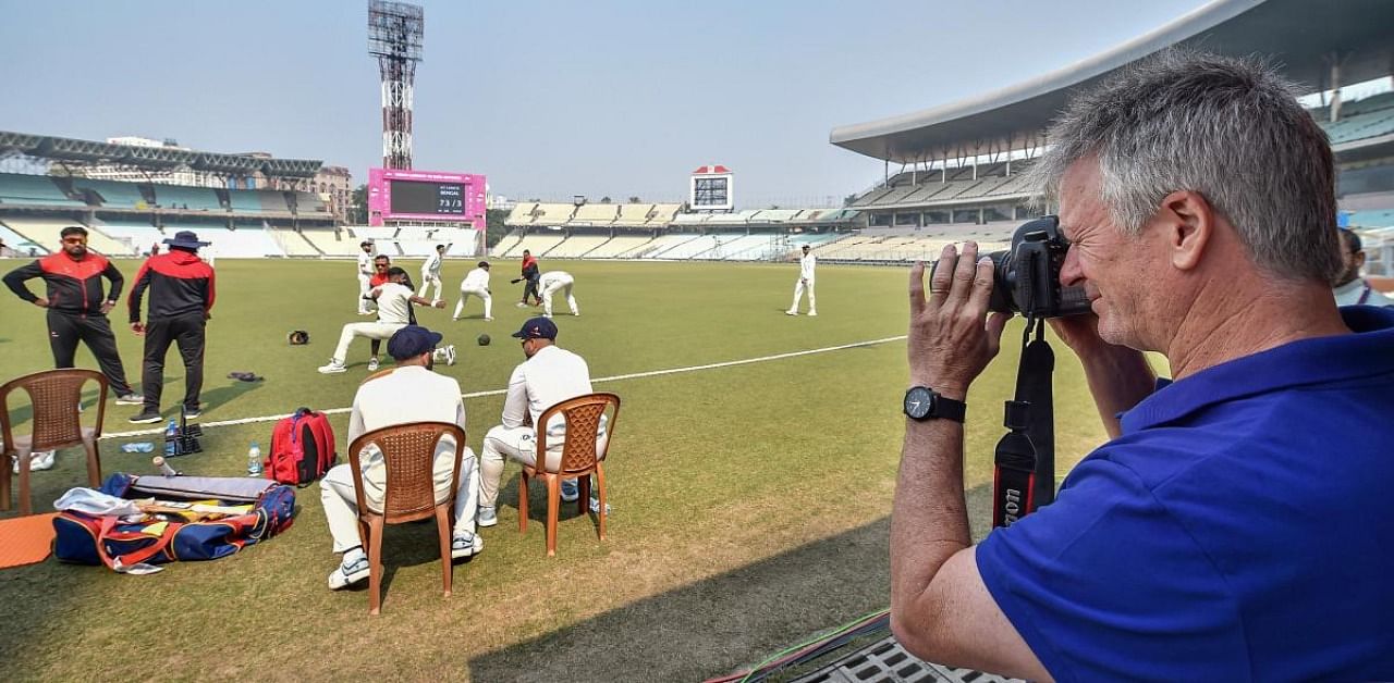 Former Australian cricket captain Steve Waugh takes pictures on a DSLR camera during a lunch break of Ranji Trophy cricket match. Credit: PTI