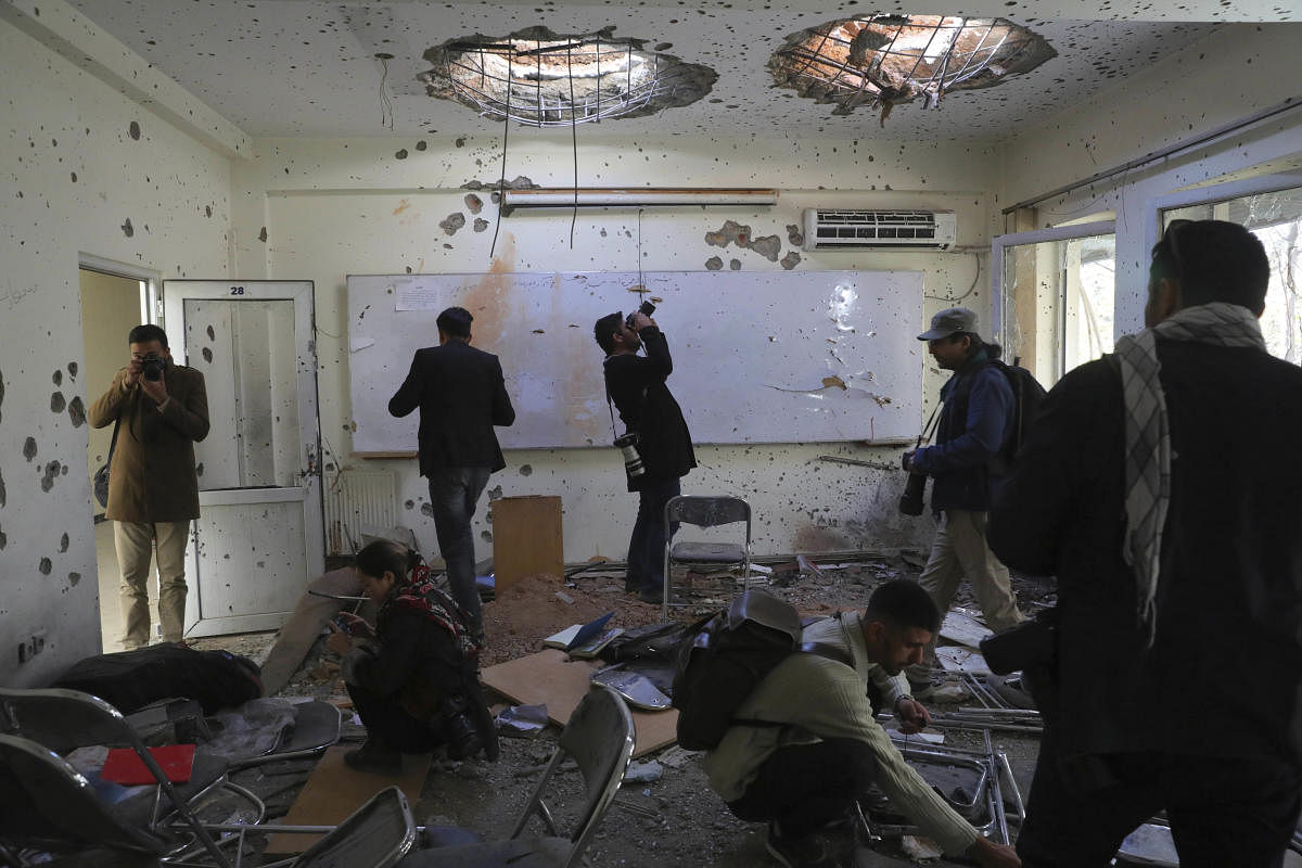 Journalists photograph inside Kabul University after a deadly attack in Kabul, Afghanistan, Tuesday, Nov. 3, 2020. The brazen attack by gunmen who stormed the university has left many dead and wounded in the Afghan capital. The assault sparked an hours-long gun battle. Credit: AP/PTI 