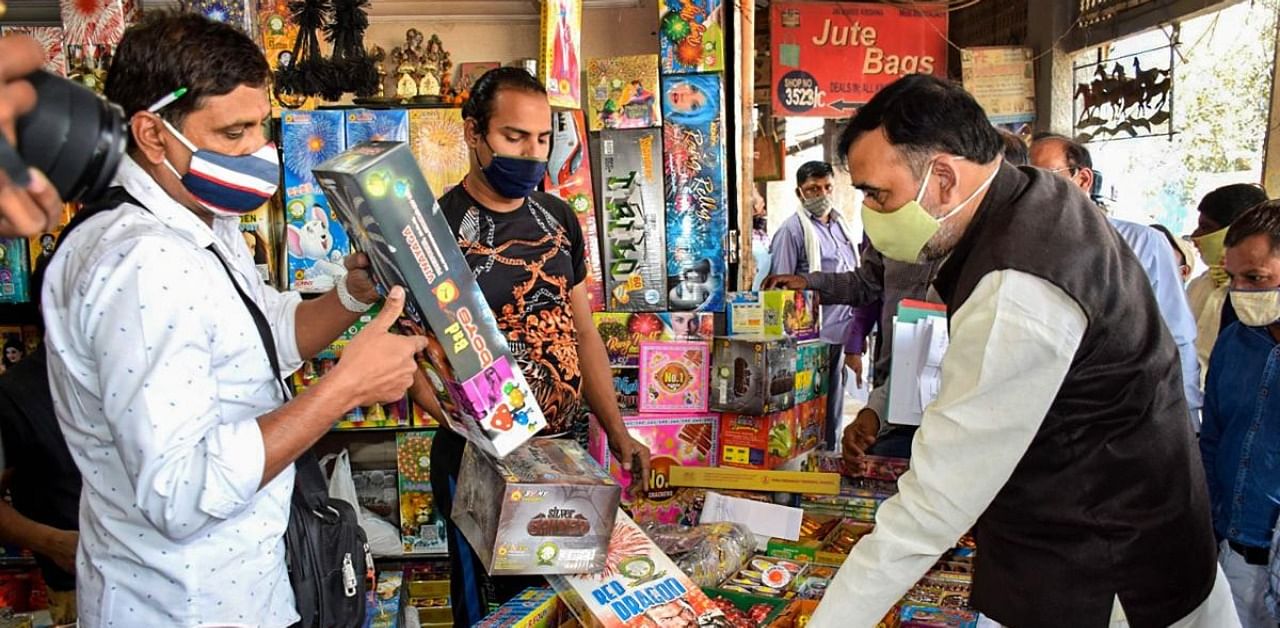 Delhi Environment Minister Gopal Rai inspects a stall during the anti-cracker campaign, in New Delhi. Credit: PTI