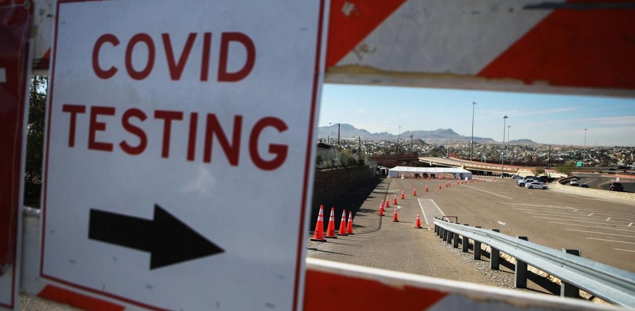 A sign directs motorists to a drive-in Covid-19 testing site amid a surge of coronavirus cases. Credit: AFP