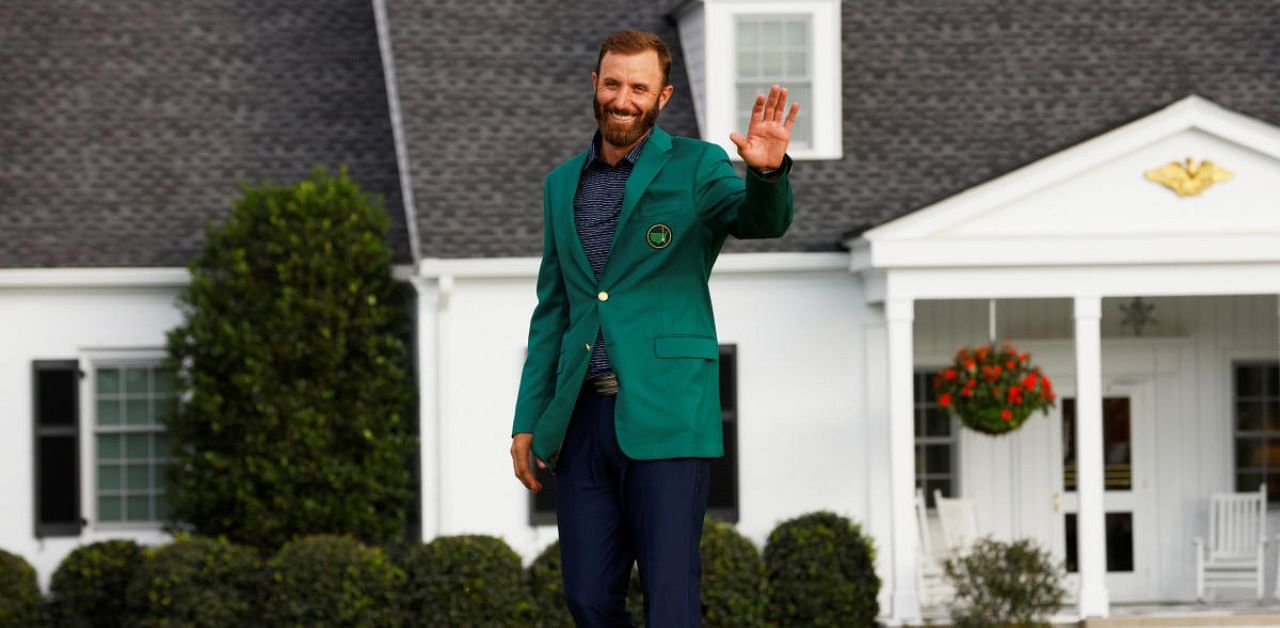 Dustin Johnson of the US celebrates with his green jacket after winning The Masters. Credit: Reuters Photo