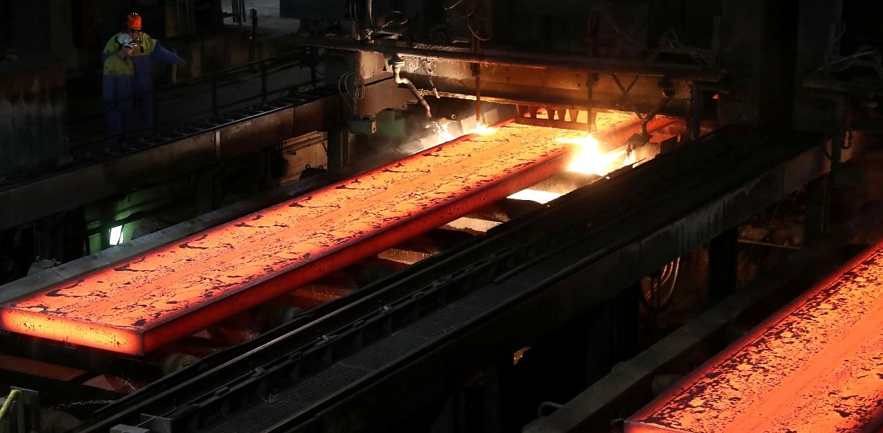 Red-hot steel plates pass through a press at the Tata steel plant in Ijmuiden, Netherlands. Credit: Reuters Photo
