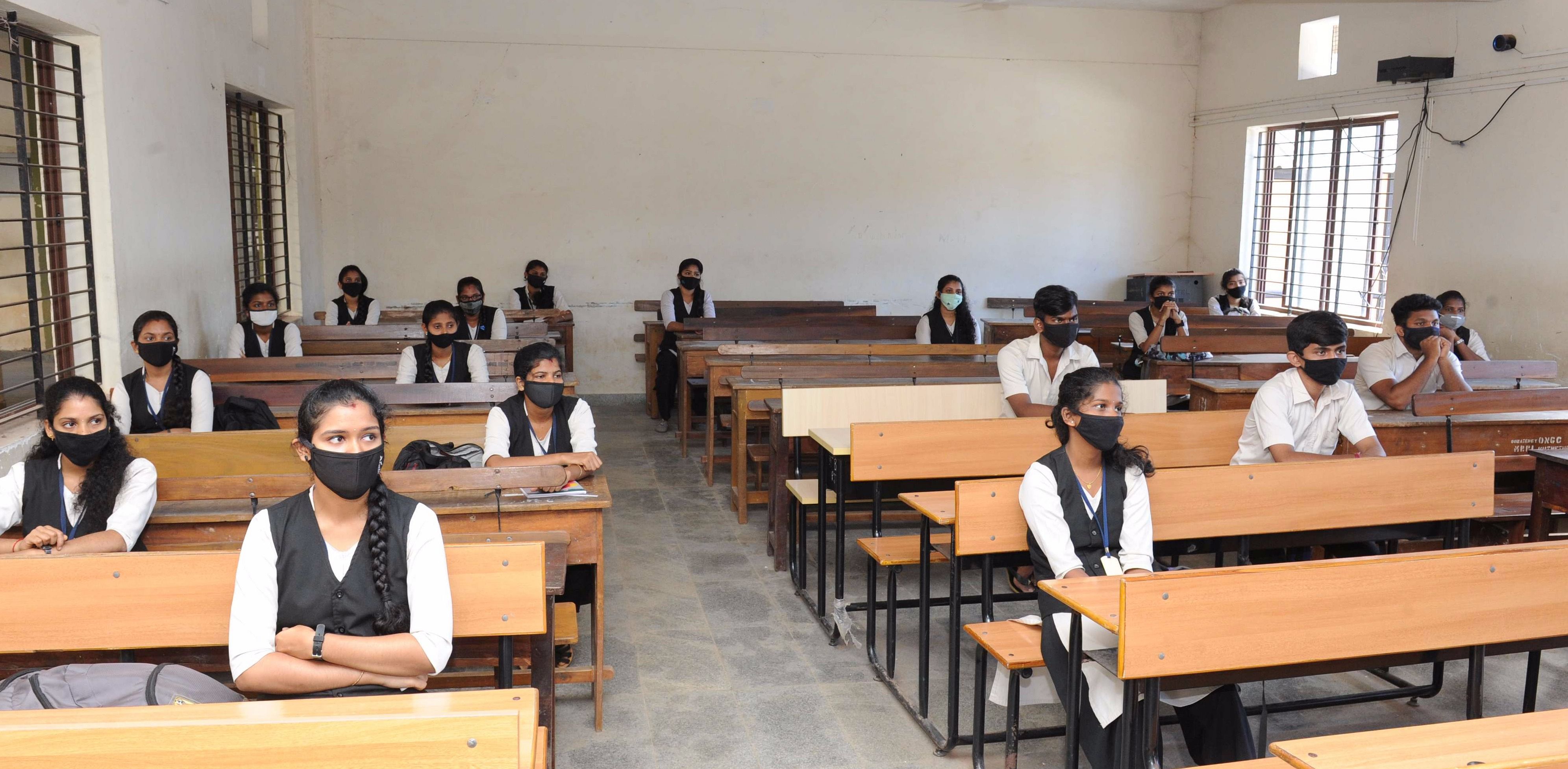 Students sitting by maintaining social distance inside a classroom in Mangaluru. Credit: DH Photo