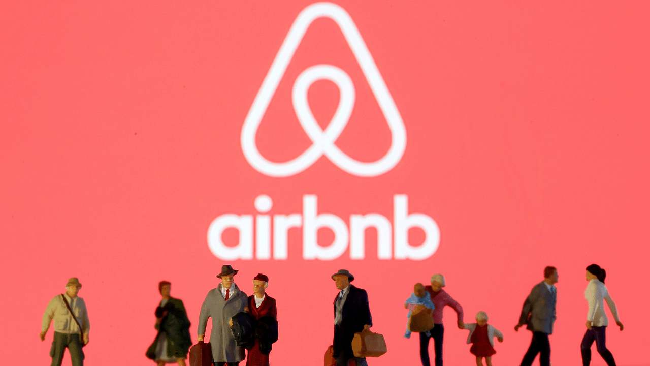 Small toy figures are seen in front of diplayed Airbnb logo. Credits: Reuters Photo