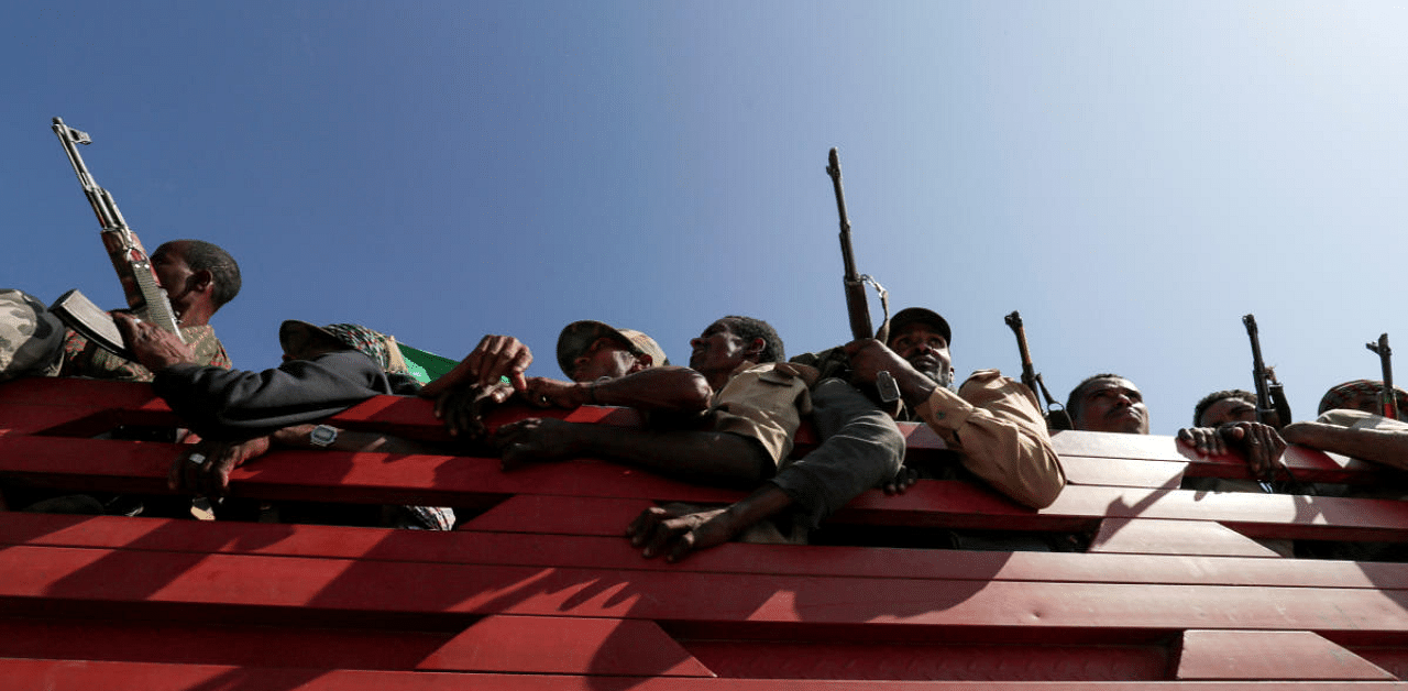 Militia members from Ethiopia's Amhara region ride on their truck as they head to face the Tigray People's Liberation Front (TPLF), in Sanja, Amhara. Credit: Reuters Photo