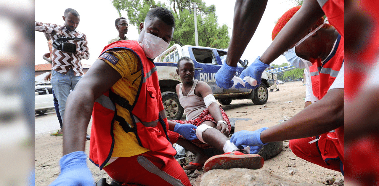 Paramedics attend to a man injured at the scene of a suicide explosion at a restaurant near a police academy, in Mogadishu, Somalia November 17, 2020.  Credit: Reuters File Photo