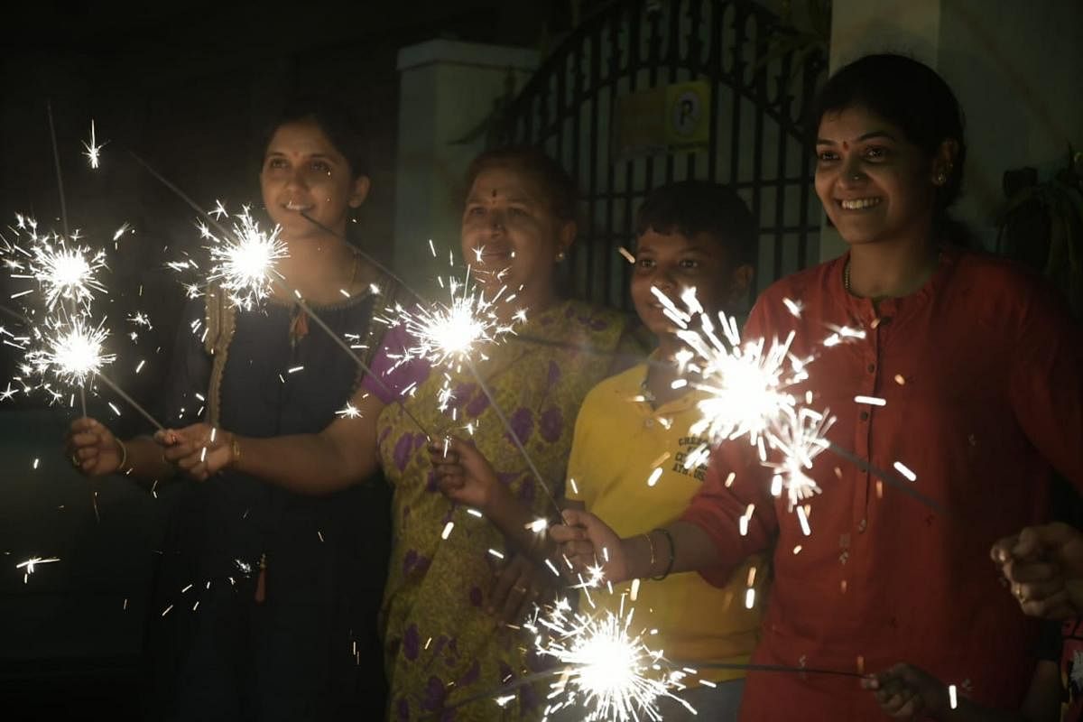 Residents of Mysuru light firecrackers on Sunday, as part of Deepavali.