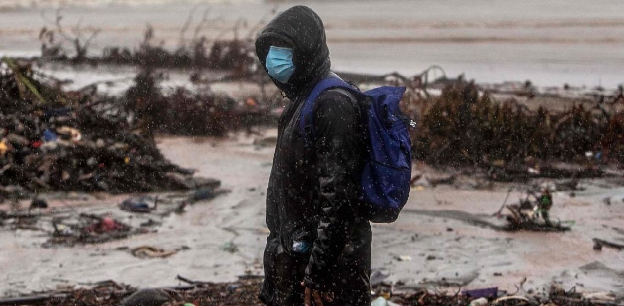 A man walsk at the beach in El Muelle neighbourhood in Bilwi, Puerto Cabezas, Nicaragua, on November 16, 2020 as Hurricane Iota -- upgraded to Category 5 -- moves over the Caribbean towards the Nicaragua-Honduras border. Credit: AFP.