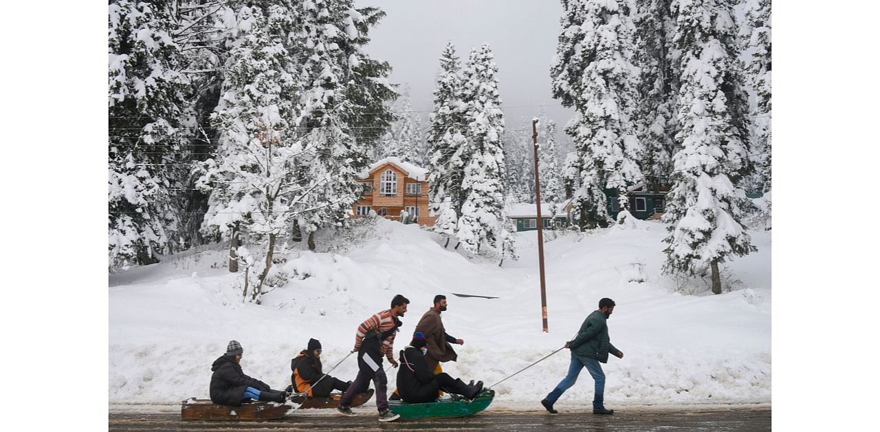 ourists take sledge ride after season's first snowfall, at Gulmarg in Baramulla district of north Kashmir. Credit: PTI