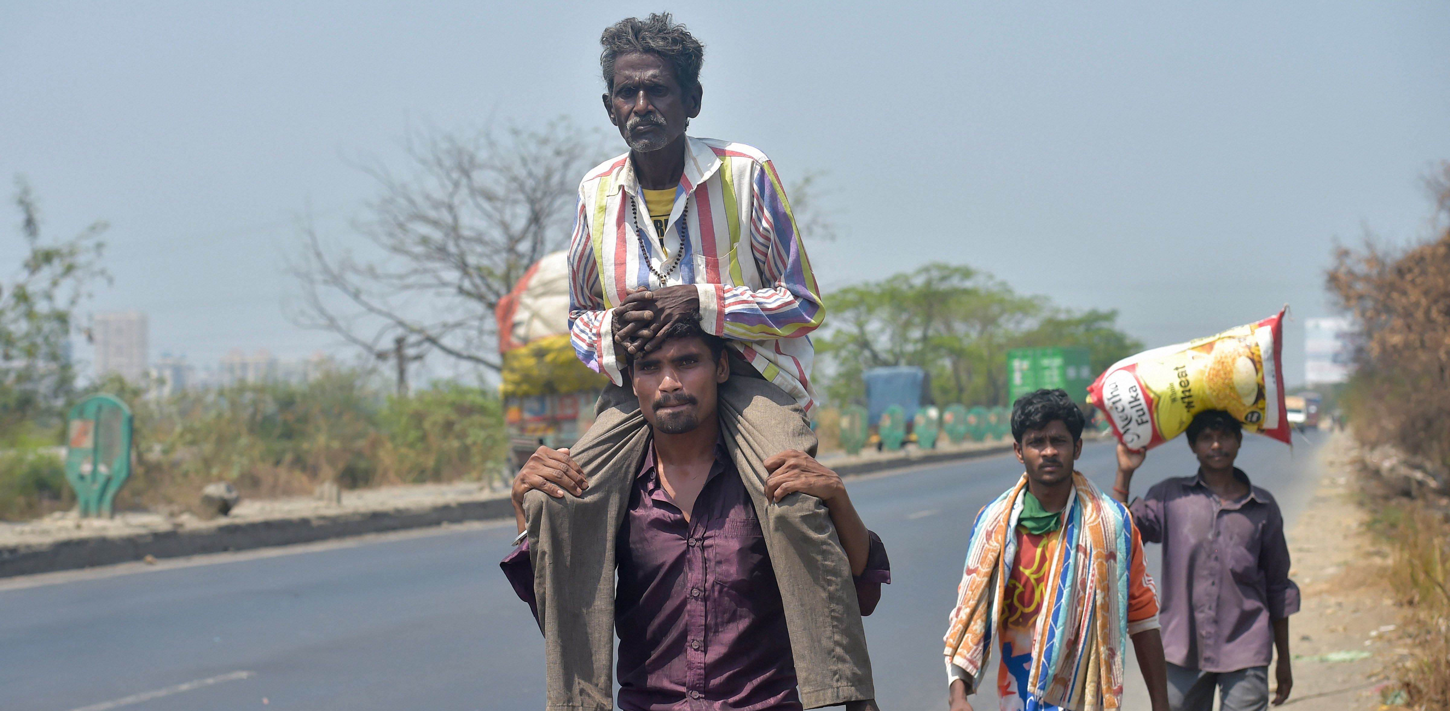 Migrant workers from Akola district of Maharashtra walk along Mumbai-Nashik highway to reach their native places, during a nationwide lockdown in the wake of coronavirus. Credit: PTI
