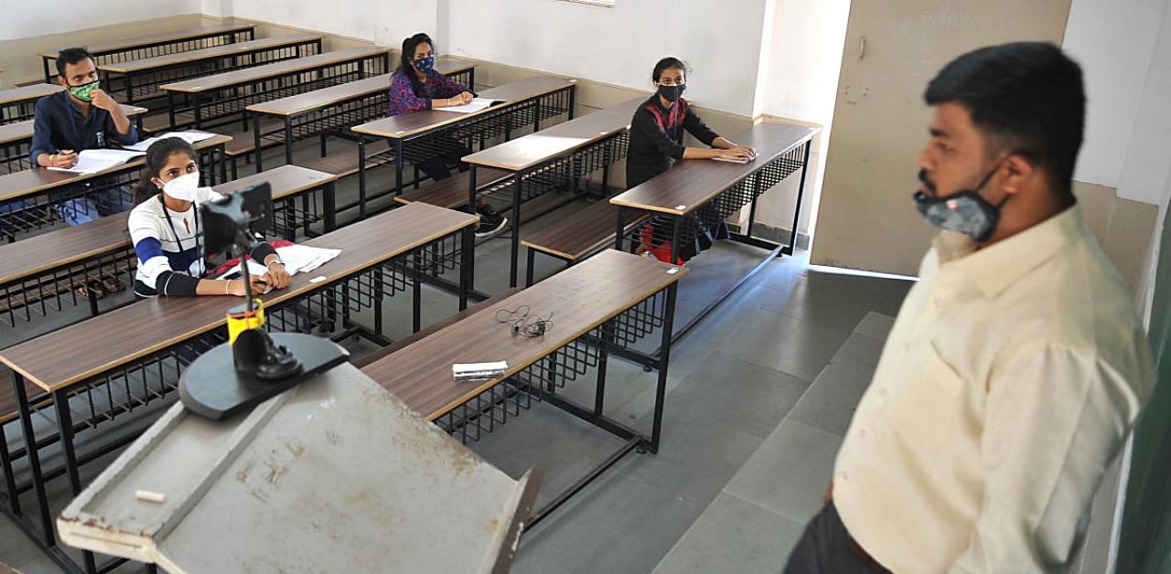 Students attend classes at Seshadripuram Degree College in Bengaluru on Tuesday as physical classes resume for the first time after Covid-19 lockdown. Credit: DH photo/Pushkar V.