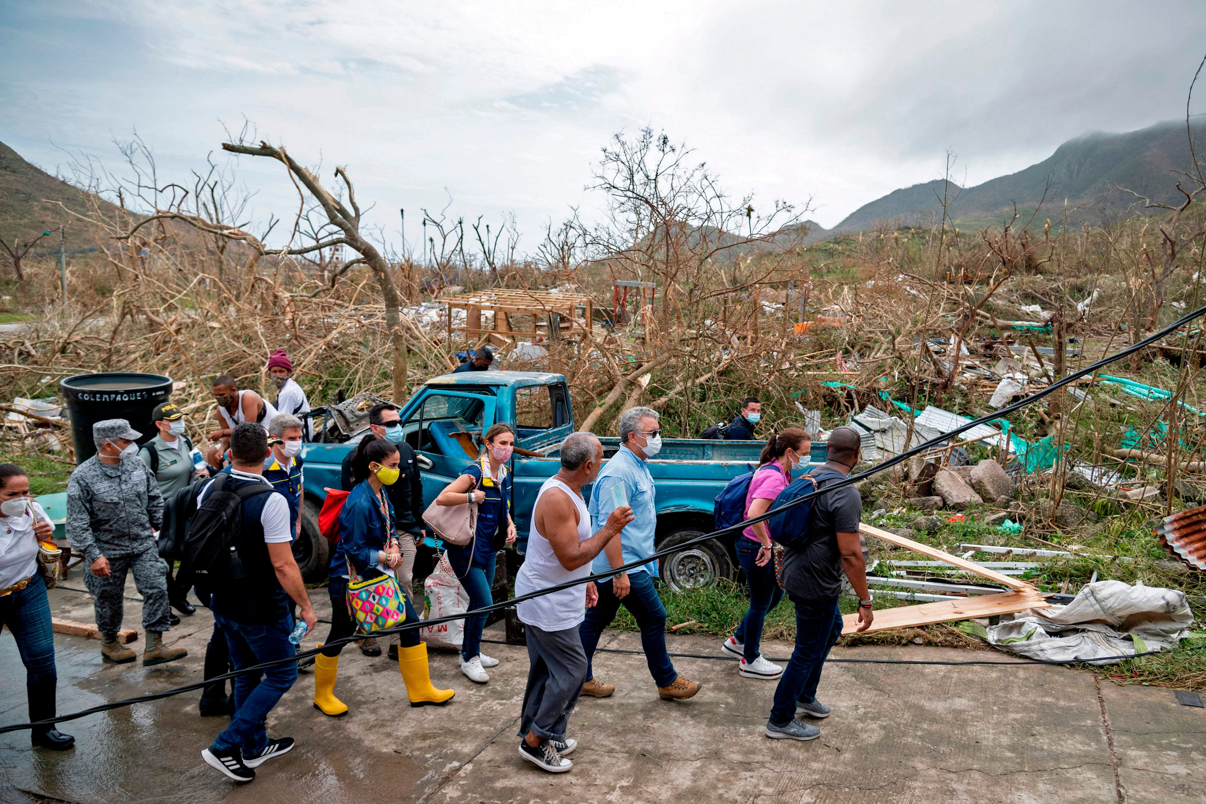   Handout photo released by the Colombian Presidency of Colombian President Ivan Duque (3-R) visiting areas damaged by Hurricane Iota in Providencia, Colombia, on November 17, 2020. - Iota left one person dead after sweeping the Colombian Caribbean island of Providencia, where it caused widespread damage. Credit: Colombian Presidency / AFP