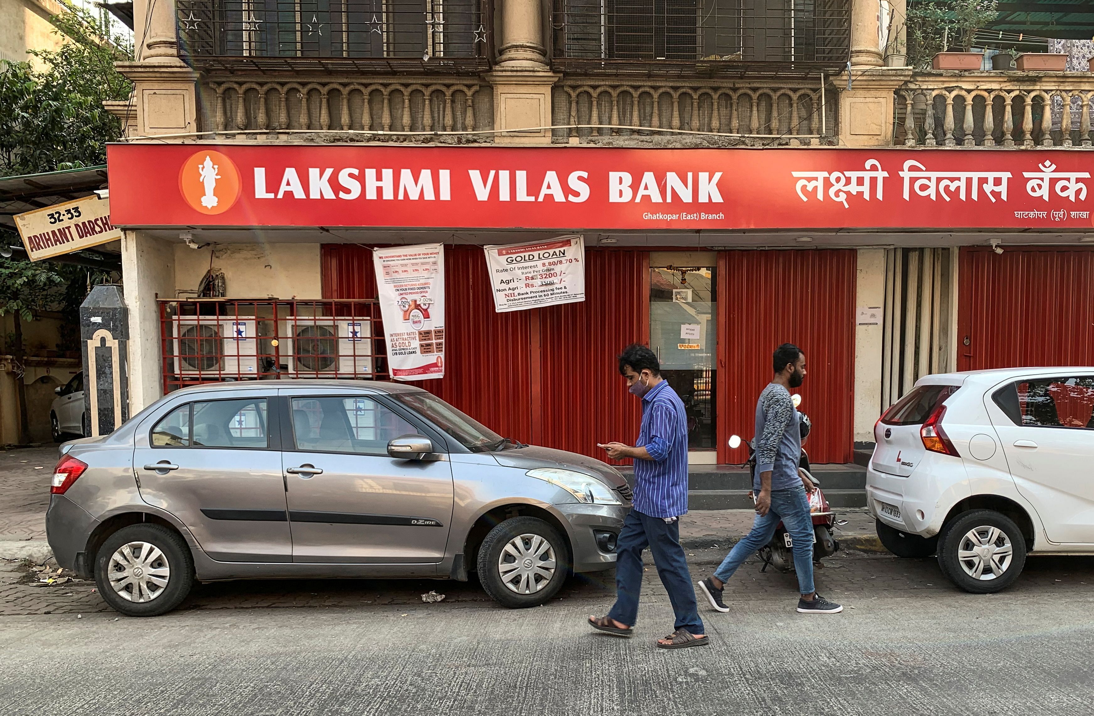 People walk past a Lakshmi Vilas Bank branch in Mumbai, India. Credit: Reuters Photo