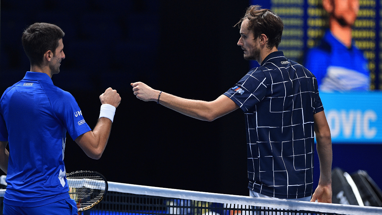 Russia's Daniil Medvedev (R) bumps fists with Serbia's Novak Djokovic after winning the match in two sets during their men's singles round-robin match on day four of the ATP World Tour Finals tennis tournament. Credit: AFP Photo