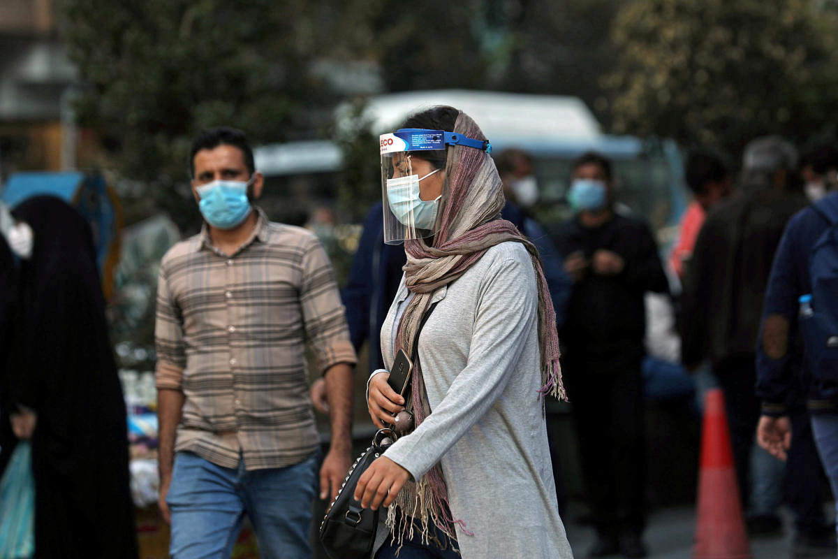 An Iranian woman wears a mask and face shield, amid a rise in the coronavirus disease in Tehran. Credit: Reuters