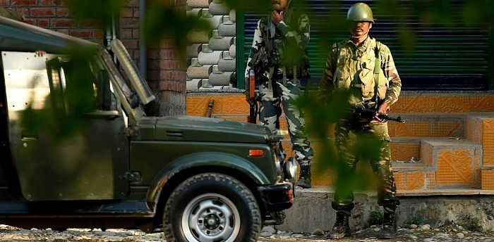 The encounter was underway till last reports came in, they said, adding that four terrorists are believed to be in the vehicle. Credit: AFP Photo