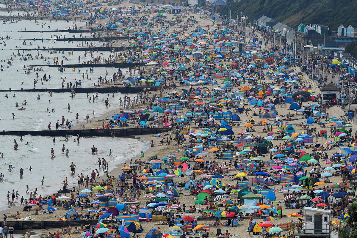 People enjoy the sunny weather at the Bournemouth Beach, amid the coronavirus disease (COVID-19) outbreak, in Bournemouth, Britain, August 7, 2020. Credit: REUTERS