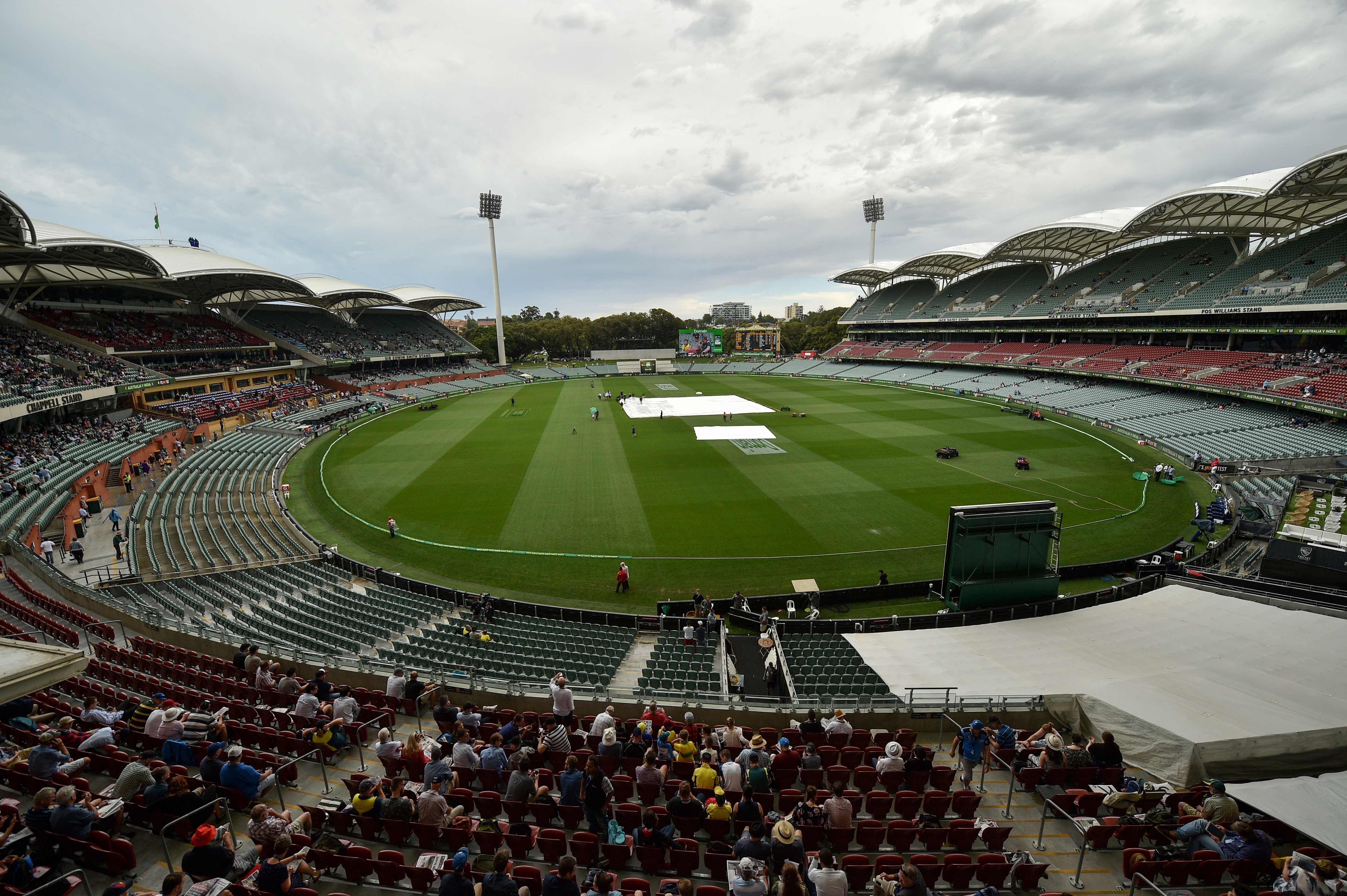 Groundsmen remove rain covers on the wicket at the start of day three of the first Test cricket match between Australia and India at the Adelaide Oval. Credit: AFP File Photo