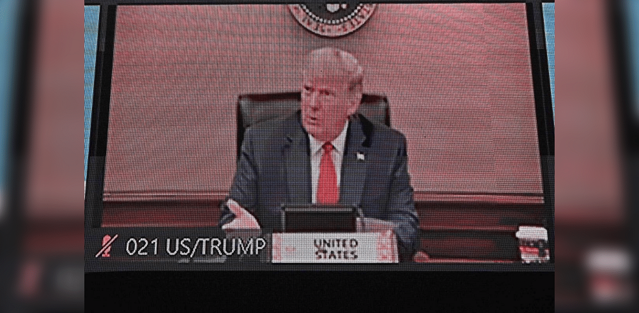 US President Donald Trump is pictured on a monitor screen as he takes part in the online Asia-Pacific Economic Cooperation (APEC) leaders' summit in Kuala Lumpur on November 20, 2020. Credit: AFP Photo