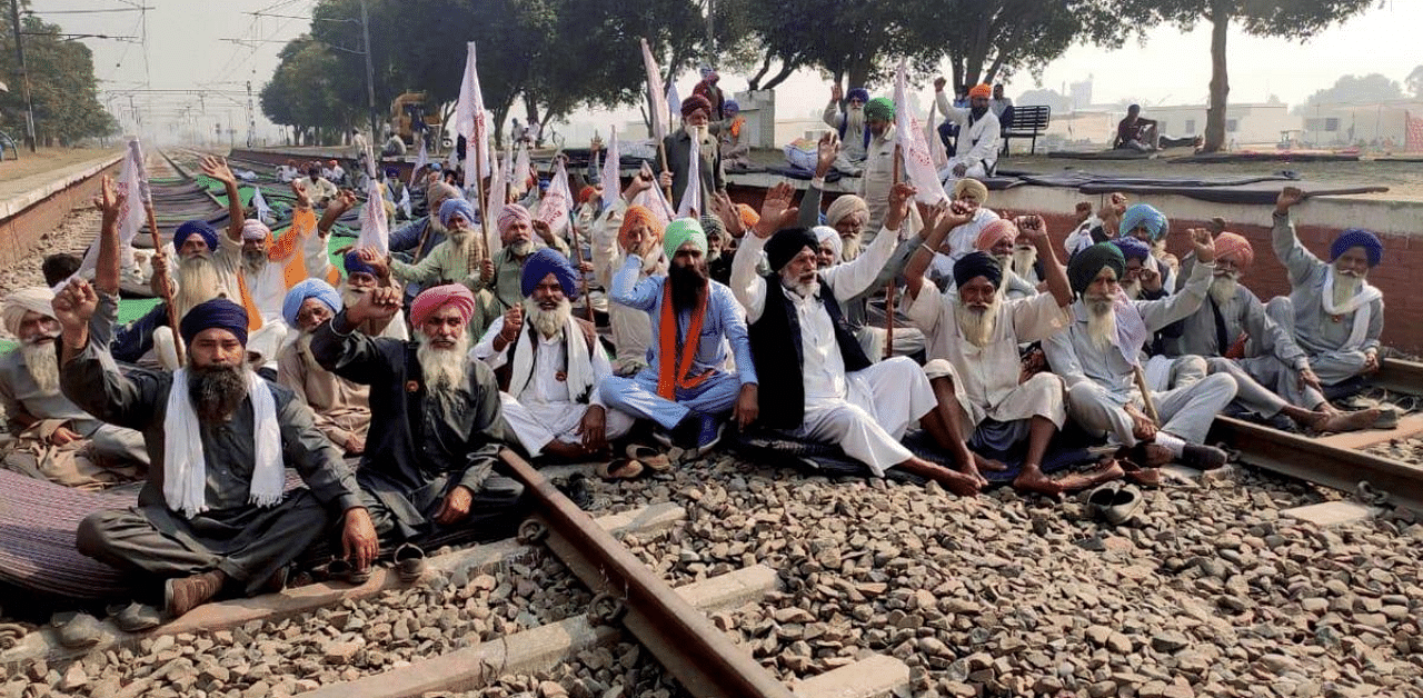 Farmers block a railway track during a protest against the new farm law, at Jandiala Guru in Amritsar. Credit: PTI Photo