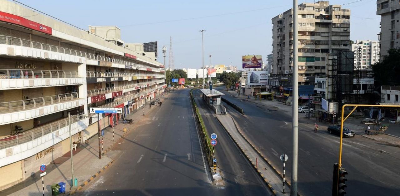 A general view of a deserted road is pictured after a curfew was imposed as a preventive measure against the Covid-19 coronavirus, in Ahmedabad. Credit: AFP.