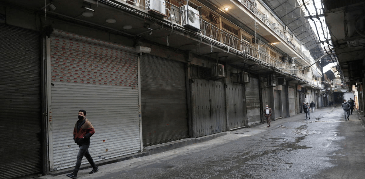 An Iranian man wearing a protective face mask, walks next to closed shops, as government imposed a full lockdown, amid the spread of the coronavirus disease, in Tehran, Iran. Credit: Reuters Photo