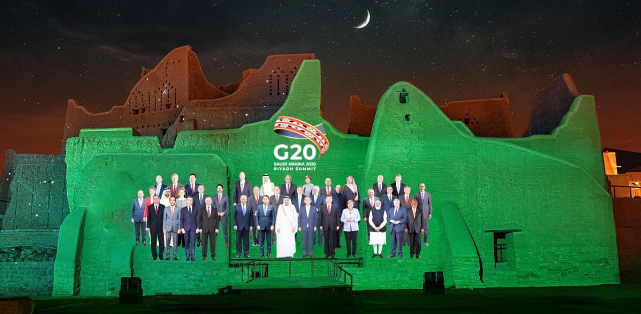 "Family Photo" for the annual G20 Summit World Leaders is projected onto Salwa Palace in At-Turaif, one of Saudi Arabia’s UNESCO World Heritage sites, in Diriyah, Saudi Arabia, November 20, 2020. Credit: Reuters/The Saudi G20 Presidency Media/Handout.