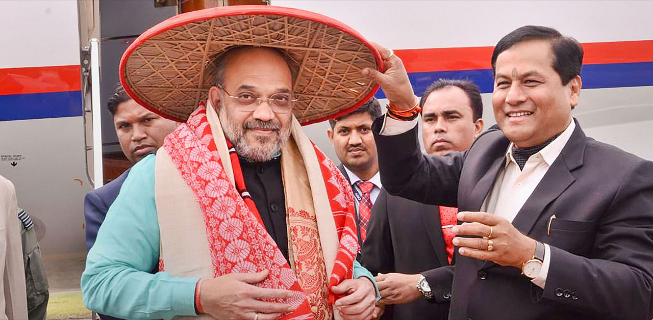 Union Home Minister Amit Shah is greeted by Assam Chief Minister Sarbananda Sonowal at the airport as he arrives to attend the 34th Statehood Day of Arunachal Pradesh, in Lakhimpur Kheri. Credit: PTI File Photo