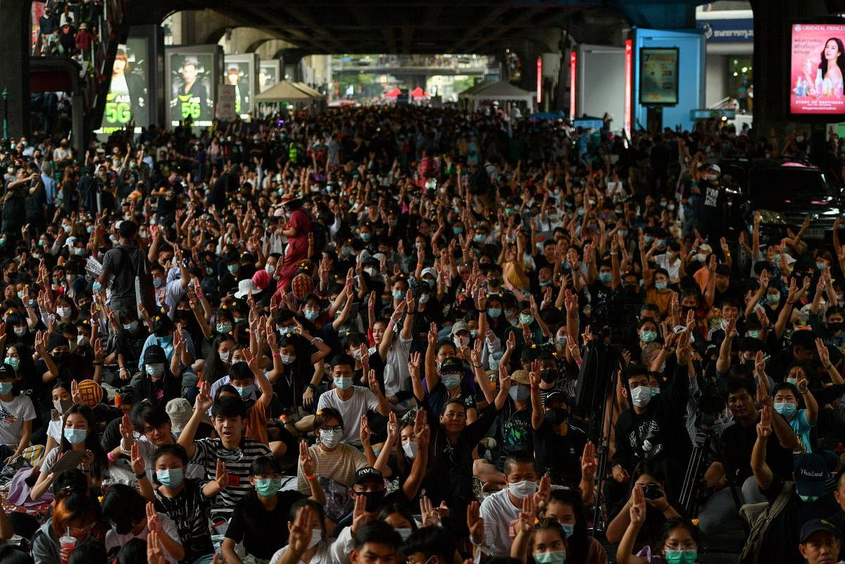 Pro-democracy protesters demanding the resignation of Thailand's Prime Minister Prayut Chan-o-cha and reforms on the monarchy show the three-fingered salute during a rally in Bangkok. Credit: Reuters