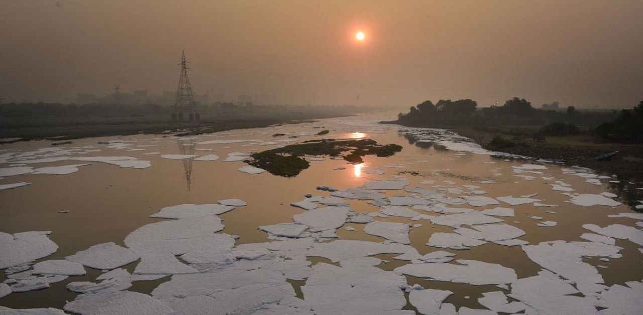 Toxic foam floats in the Yamuna river, during sunset in New Delhi. Credit: PTI Photo