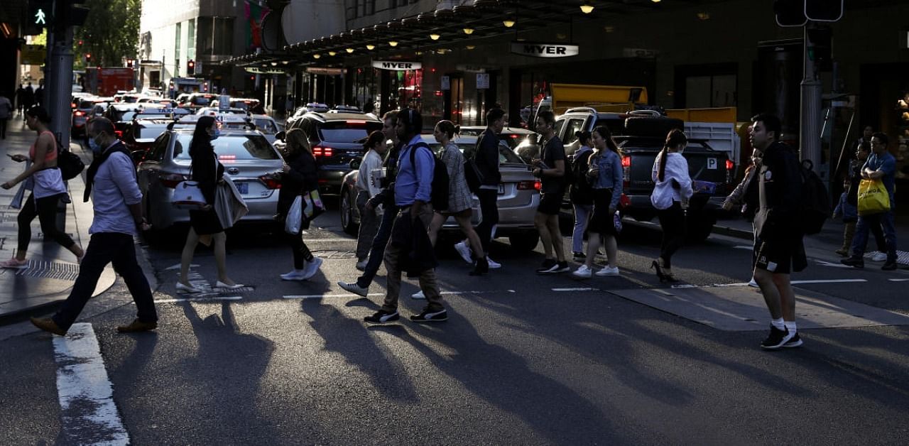 People walk through a congested intersection in the city centre of Sydney, Australia. Credit: Reuters Photo