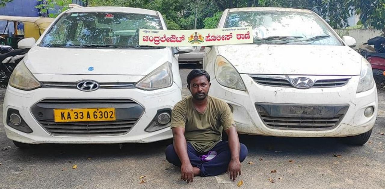 Arrested car dealer Mohammed Muzzamil with the stolen vehicles. Credit: DH photo.