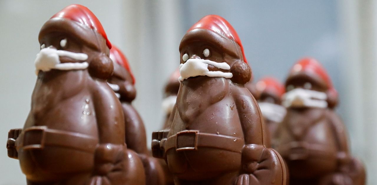 Chocolate Santas wearing protective face masks are seen in the workshop of the Hungarian confectioner Laszlo Rimoczi. Credit: Reuters Photo