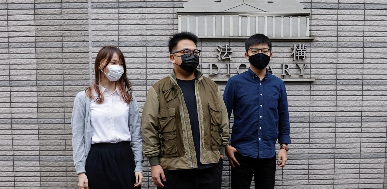 Pro-democracy activists Ivan Lam, Joshua Wong and Agnes Chow arrive at the West Kowloon Magistrates' Courts to face charges related to illegal assembly stemming from 2019, in Hong Kong. Credit: Reuters Photo