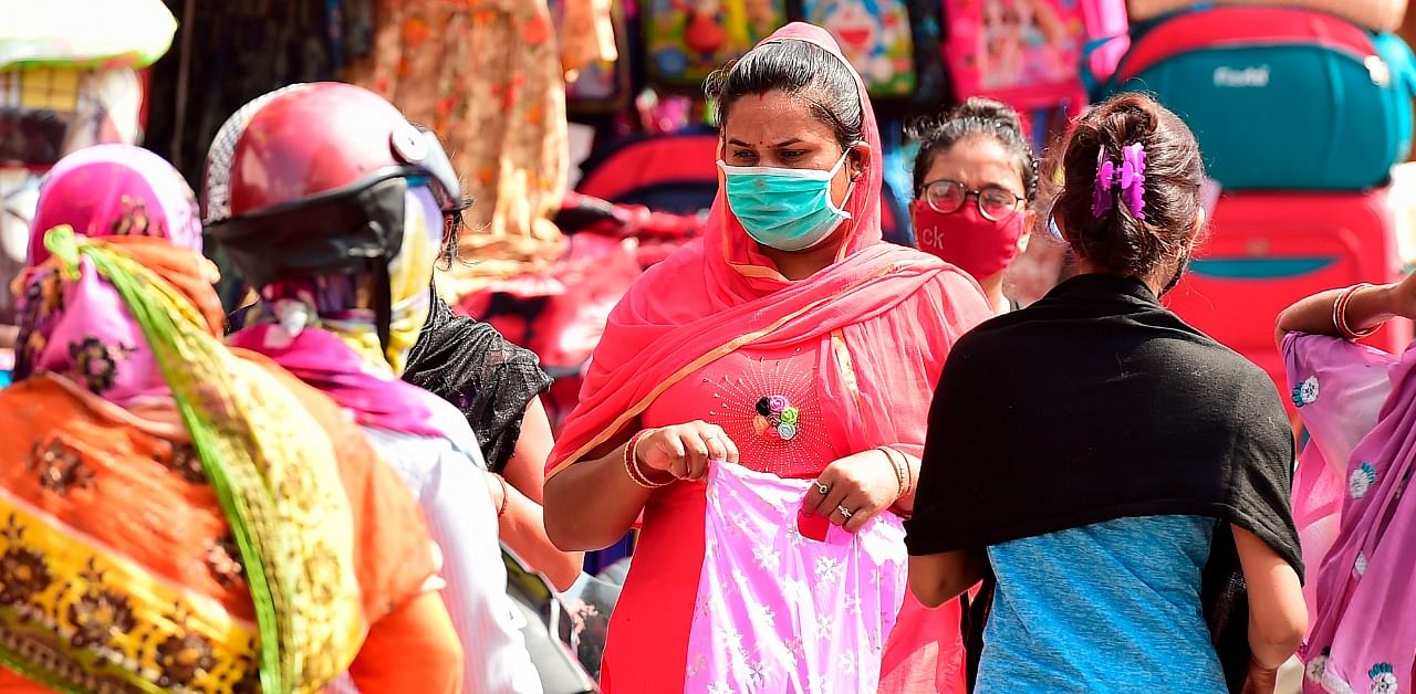 People walk and shop at a market in old neighborhood of Chowk, in Allahabad. Credit: AFP Photo