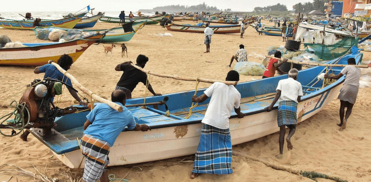 Fishermen shift their boats for safety following Cyclone Nivar alert, in Mamallapuram. Credit: PTI Photo
