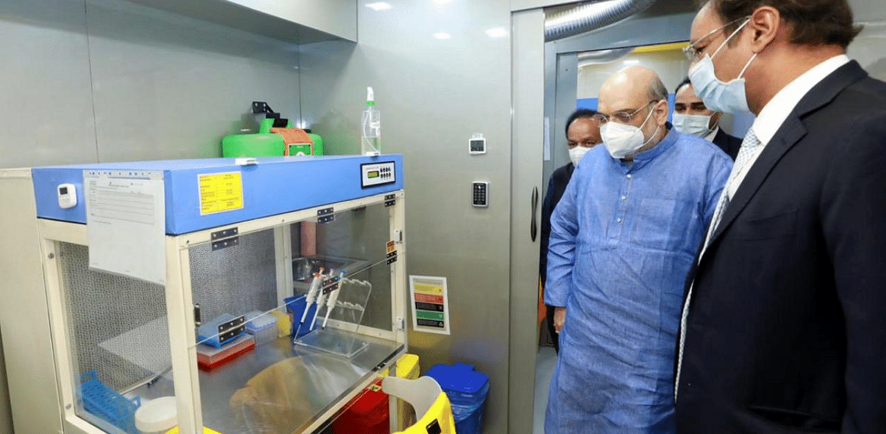  Union Home Minister Amit Shah and Spicejet CMD Ajay Singh during the launch of mobile RT-PCR lab at ICMR headquarters, in New Delhi. Credit: PTI Photo