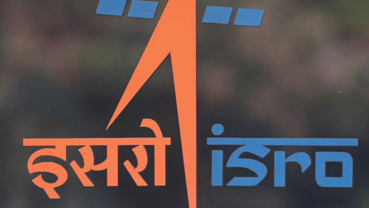 A security guard stands behind the logo of Indian Space Research Organisation (ISRO). Credit: Reuters Photo