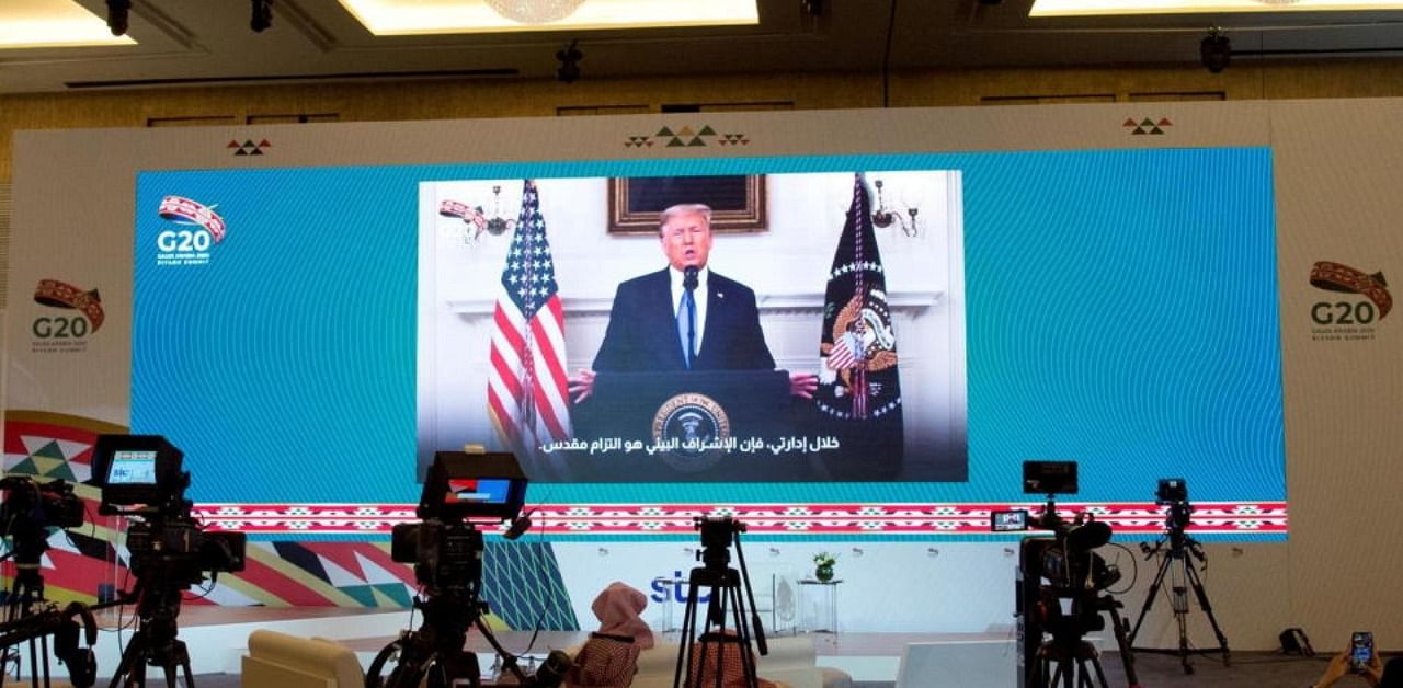 US President Donald Trump's virtual speech is aired live in media centre of the 15th annual G20 Leaders' Summit, in Riyadh. Credit: Reuters Photo