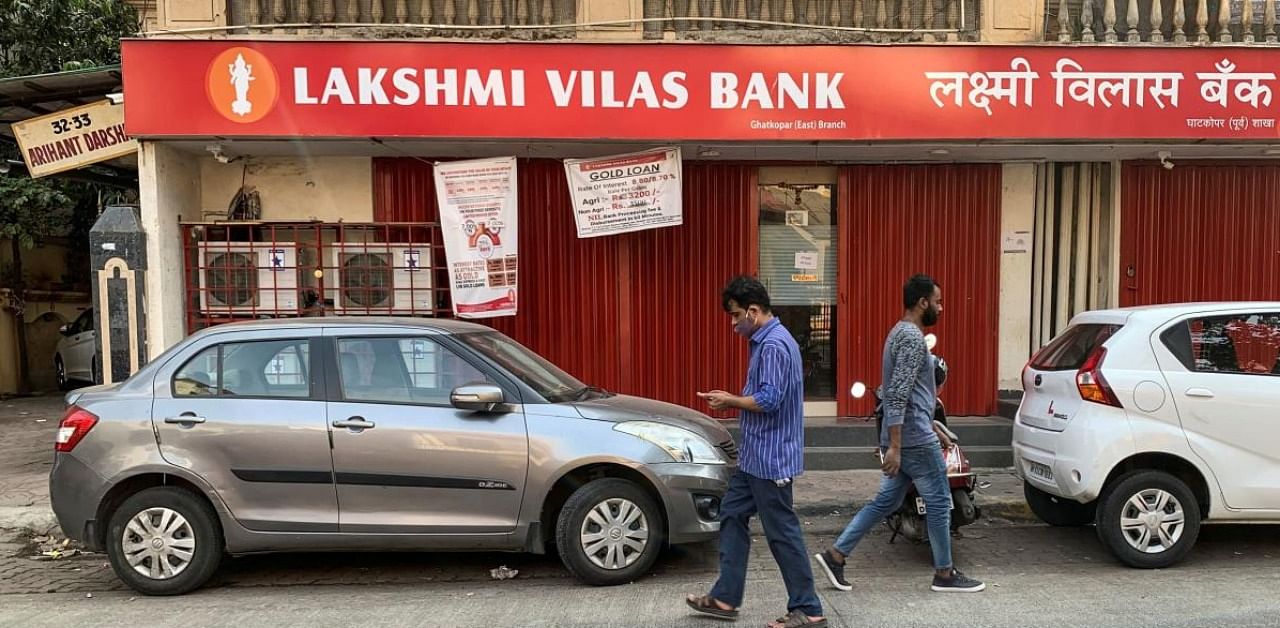 People walk past a Lakshmi Vilas Bank branch in Mumbai. Credit: Reuters.