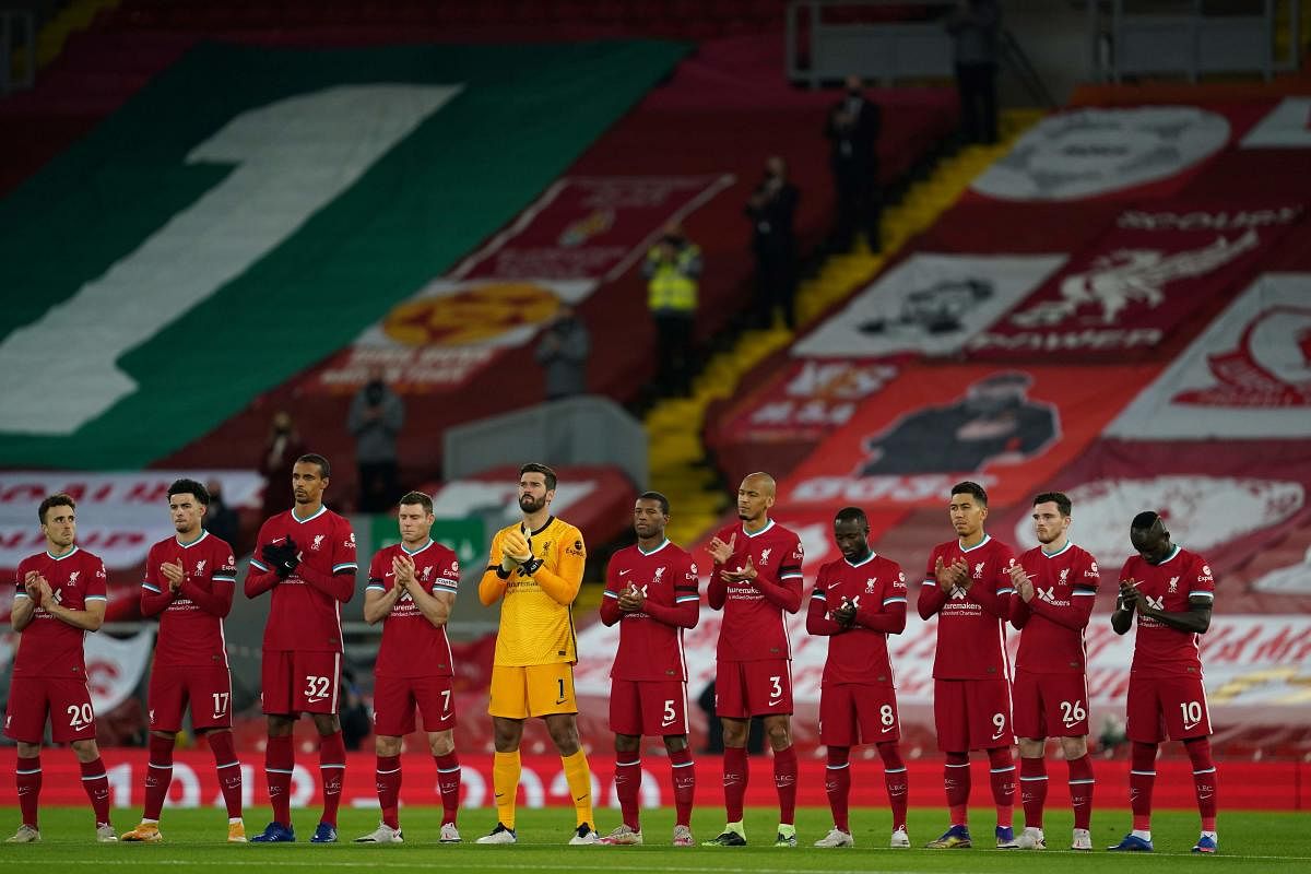 Liverpool players applaud during a minute silent in tribute to late Liverpool's goalkeeper Ray Clemence prior to the English Premier League football match between Liverpool and Leicester City at Anfield. Credit: AFP