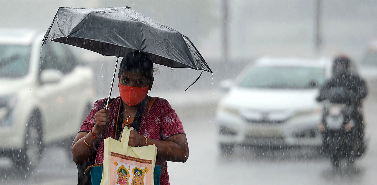 A women walks under an umbrella during heavy rains as cyclone Nivar approaches the eastern Indian coast, in Chennai. Credit: AFP Photo