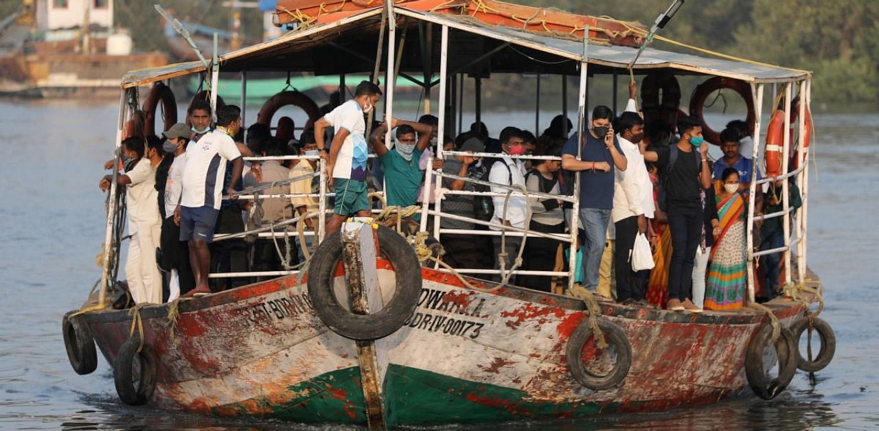 Commuters wearing protective masks travel in a ferry amid Covid-19 pandemic. Credit: Reuters Photo