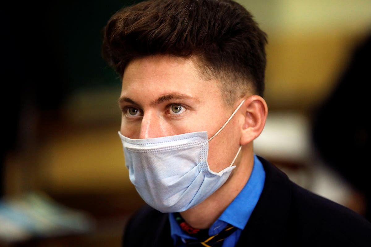 A student wears a protective mask while attending a class at school as the outbreak of the coronavirus continues, in Peshawar, Pakistan. Credit: Reuters
