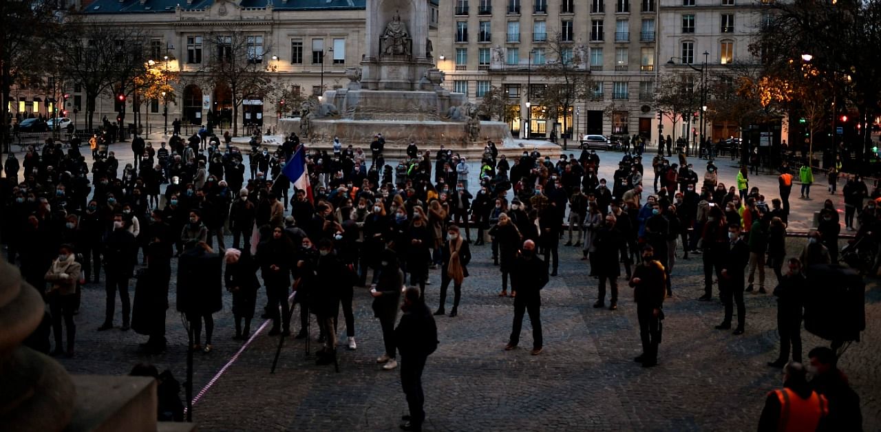 People gather outside the Saint-Sulpice Church to protest against the closure of places of worship during a second lockdown to curb the spread of Covid-19, in Paris on November 22. Credit: AFP Photo