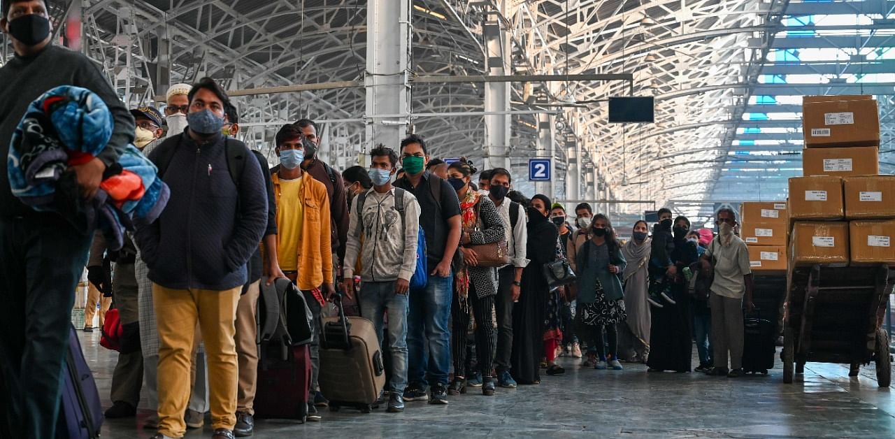 Passengers stand in a queue at the platform for the Covid-19 medical screening after arriving from New Delhi at the railway station in Mumbai. Credit: AFP Photo