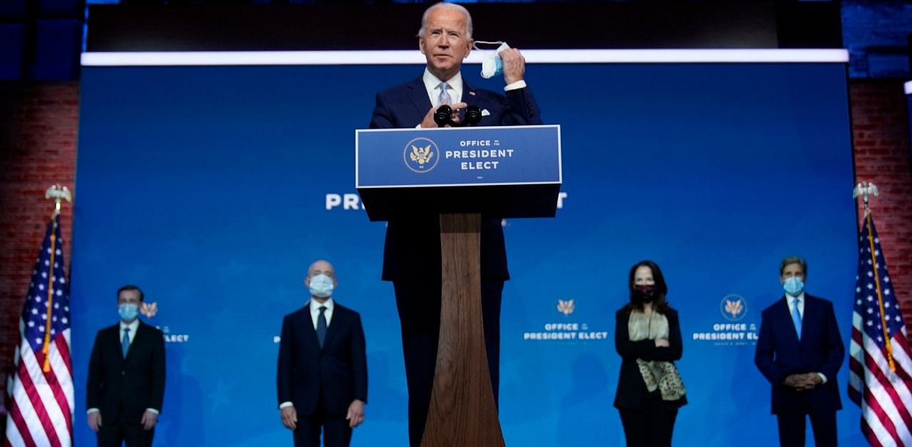  President-elect Joe Biden removes his face mask as he arrives to introduce his nominees and appointees to key national security and foreign policy posts at The Queen theater. Credit: AP/PTI Photo