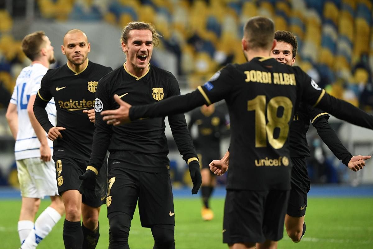 Barcelona's French midfielder Antoine Griezmann (C) celebrates with teammates after scoring his team's fourth goal during the UEFA Champions League group G football match between Dynamo Kiev and Barcelona at the Olympiyskiy stadium in Kiev. Credit: AFP