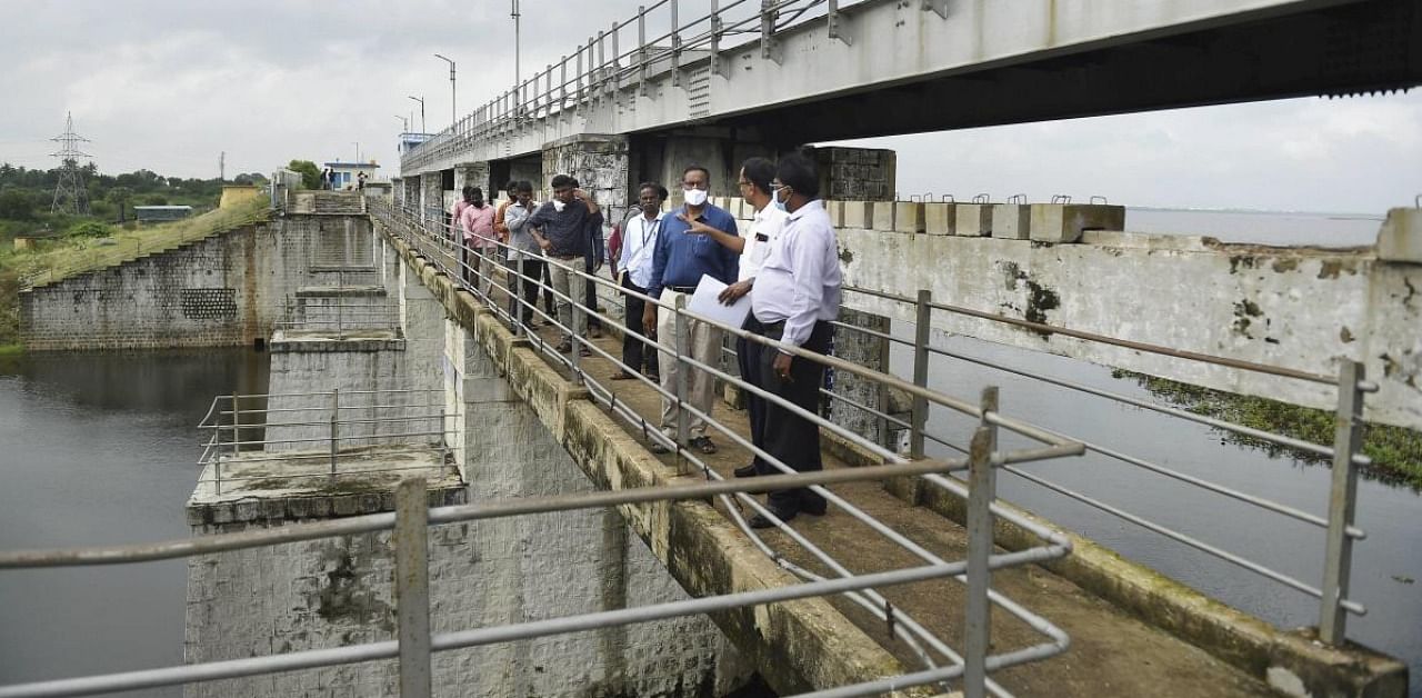 Officials inspect Chembarambakkam lake, after it reached 80% of its capacity following heavy rainfall, in Chennai. Credit: PTI.