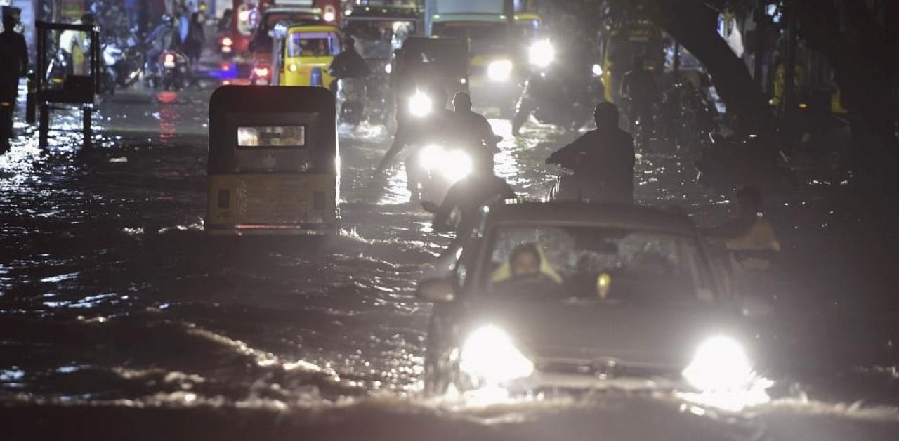 Vehicles ply on a waterlogged road during heavy rain triggered by Cyclone Nivar, in Chennai, Tuesday, Nov. 24, 2020. Credit: PTI Photo